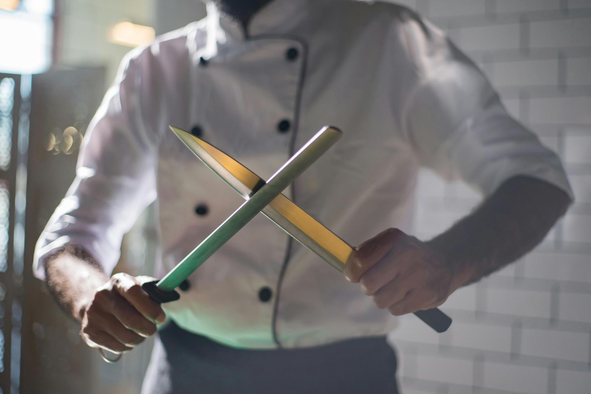 Chef demonstrating knife technique to students